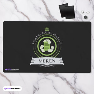 May include: Black playmat with a green recycling symbol and the words "Reduce, Reuse, Recycle" around it. The word "Meren" is written in white below the symbol. The playmat has a white border.
