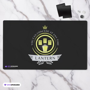 May include: Black playmat with a gold and yellow design. The design features a lantern with four cards around it. The text reads "You can concede at any time" and "Lantern".