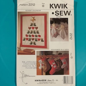 May include: A Kwik Sew pattern envelope 2212 featuring instructions for an advent calendar, angel ornaments, and stockings in five sizes. The white paper envelope displays color photographs of the finished projects, text, a barcode, and company details.