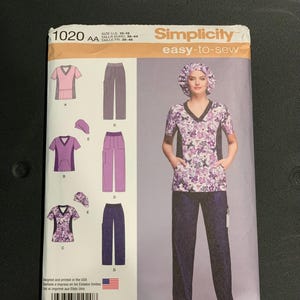 May include: Simplicity sewing pattern 1020 for a V-neck scrub top, pants, and a scrub cap. The pattern envelope displays illustrations of three different scrub sets in various purple and floral patterns, with U.S. sizes ranging from 10 to 18.