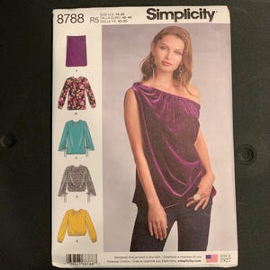 May include: A Simplicity sewing pattern envelope 8788 for sizes 14-22. The front shows a purple one-shoulder velvet top and illustrations of five different top variations including floral, teal, patterned, and yellow designs with long sleeves.