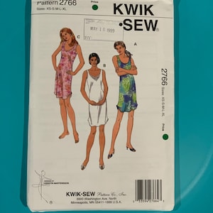 May include: A Kwik Sew pattern envelope 2766 for sizes XS-S-M-L-XL. The front displays three illustrations of sleeveless dresses labeled A, B, and C. Dress A is blue and green, B is white with lace detail, and C is pink with a floral pattern.