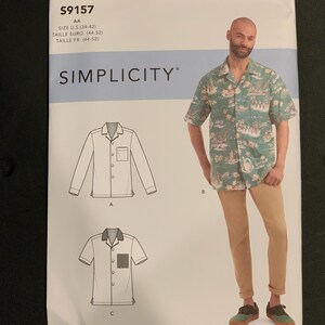 May include: Simplicity sewing pattern S9157 for a button-down shirt with a notched collar and chest pocket. The envelope displays technical line drawings of long and short-sleeve versions alongside a photograph of a green tropical print shirt.