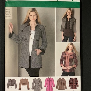 May include: Simplicity sewing pattern featuring a woman modeling a gray coat with black trim. The pattern includes multiple coat designs, sizes R5 14, 16, 18, 20, 22, and the Simplicity logo. The pattern also includes a barcode.