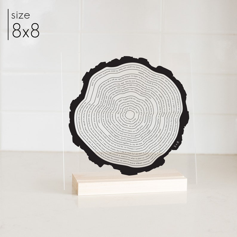 This is a tree ring acrylic stand art. It is printed in black and in a wood stand. It is personalized to your story.