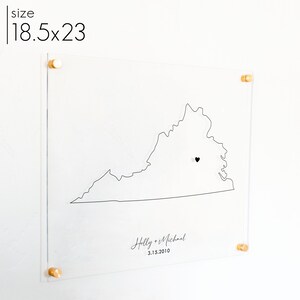 This wall art is an acrylic sign with the state of Virginia and a heart marks the location where a couple met. Name, date, and state are all printed in black.