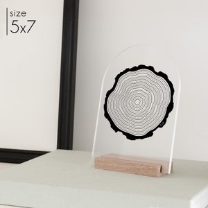 This is an acrylic arch tree ring art in a wood stand. This is printed in black.