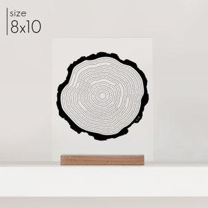 Tree ring acrylic art. Tells a story and is personalized to your story. Printed in black on clear acrylic in a wood stand.