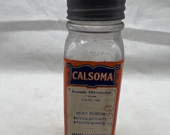 May include: A glass bottle with a black lid containing a white powder. The label is orange and blue and reads "CALSOMA Granular Effervescent 2 ounces List No. 1496 FOR ACID INDIGESTION Neutralizing gastric acidity without producing alkalinity: ABBOTT LABORATORIES NORTH CHICAGO, ILL. U.S.A."