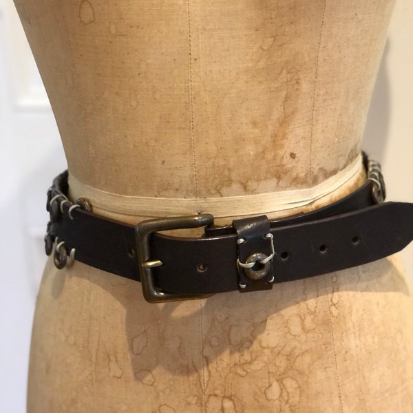 Nice Chunky 1990s Brown Leather Belt with Brass Rings attached with String, and Brass tone Buckle, Marked Dolce Vita made in Italy.