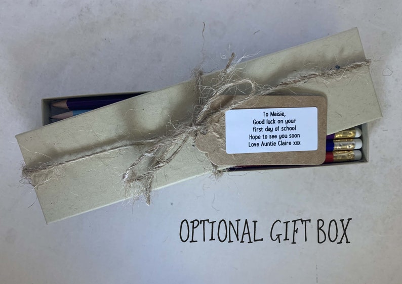 May include: A brown cardboard box tied with twine and a gift tag. The tag has a handwritten message that reads "To Maisie, Good luck on your first day of school Hope to see you soon Love Auntie Claire xxx". The box is labeled "OPTIONAL GIFT BOX".