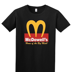 May include: Black t-shirt with a yellow "M" logo and the text "McDowell's Home of the Big Mick!"