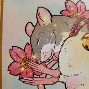May include: Illustration of a rat with gray fur, pink ears, and a pink nose, surrounded by pink cherry blossoms. The rat has a red rope and a gold bell. The background is a soft, light blue and yellow.