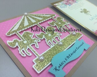 May include: A pink and gold glitter invitation with a white cutout of a carousel with horses. The invitation reads "Kiki's Wonderful Carousel".