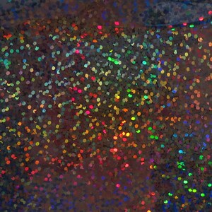 May include: A close-up of iridescent holographic glitter with a variety of colours, including blue, green, red, and gold.