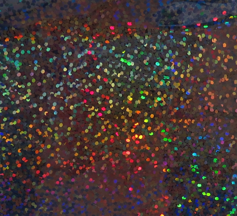May include: A close-up of iridescent holographic glitter with a variety of colours, including blue, green, red, and gold.
