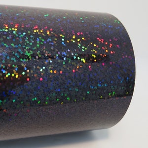 May include: A roll of black iridescent vinyl with a holographic finish. The vinyl has a subtle sparkle and is perfect for crafting projects.
