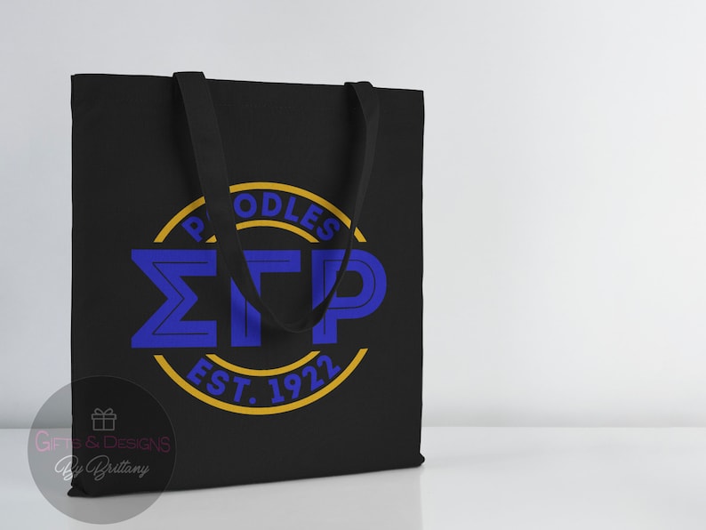 May include: Black canvas tote bag with a yellow circle and blue lettering that reads "Poodles &Sigma;TP Est. 1922".