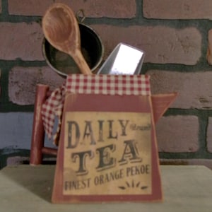 May include: A white ceramic mug with a black handle and the text "But First, Coffee" in a black, bold font. The mug is on a white surface.