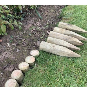 Short 10"pointed round wooden edging stakes 60mm diameter - 16 stakes will cover a 1 meter run set side by side. Lawn edging, path edging
