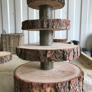 Four  tiered rustic wooden log wedding cake cup stand with large base and carved heart personalised.