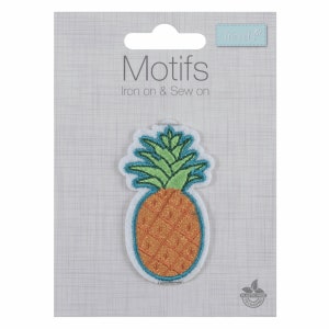 May include: Iron-on or sew-on pineapple patch with a green top and orange body. The patch is on a white card with the text "Motifs Iron on & Sew on" and a small logo that says "Trimits".