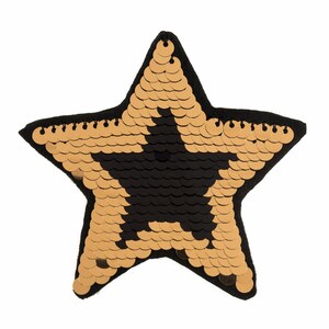 May include: A gold star-shaped patch with black sequins in the center. The patch is made of fabric and has a black border.