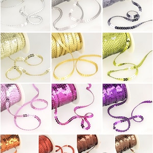 May include: Assortment of ten spools of sequined trim in various colours, including silver, gold, lime green, purple, and copper. Each spool features a continuous length of trim with small, round sequins.
