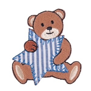 May include: A brown teddy bear holding a blue and white striped star. The bear has a stitched smile and embroidered eyes.