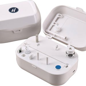 May include: A white and grey electronic device with a hinged lid and a blue button. The lid has a logo with a blue "H" inside a white oval. The device is open, revealing internal components.