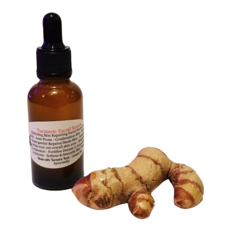 May include: A brown glass bottle with a black dropper and a label reading "Turmeric Facial Serum" sits next to a turmeric root. The serum is for hydrating and repairing skin. The turmeric root is a light brown color.