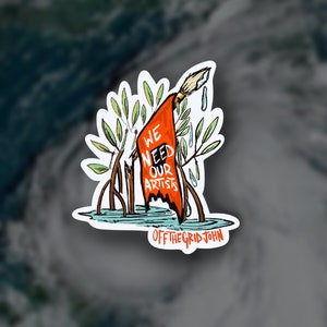 May include: A sticker with a hand-drawn illustration of a red flag with the words "We Need Our Artists" written on it. The flag is held by a paintbrush and is surrounded by green leaves. The text "OFF THE GRID JOHN" is written below the flag.