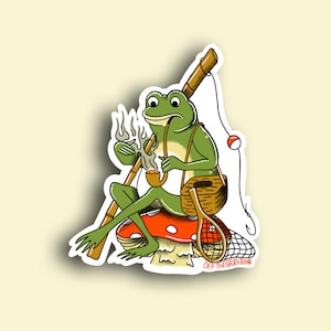 May include: A green frog sitting on a red and white mushroom, smoking a pipe and holding a fishing rod. The frog is wearing a brown wicker basket and has a fishing net and a bobber on the rod. The text "OFF THE GRID JOHN" is at the bottom of the image.