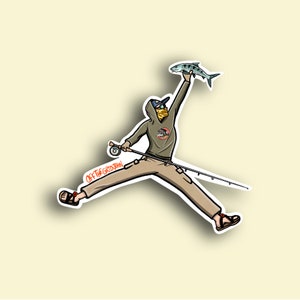 May include: A cartoon illustration of a person wearing a brown hooded sweatshirt, a yellow face mask, and khaki pants, jumping in the air while holding a fishing rod and a fish. The text "OFF THE GRID JOHN" is written on the fishing rod.