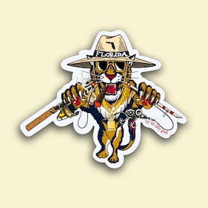 May include: A cartoon illustration of a Florida panther wearing a hat with the word "Florida" on it, sunglasses, and a gold chain. The panther is holding a fishing rod and a cigar. The text "Off the Grid Grown" is visible in the bottom right corner.