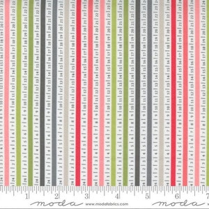 May include: A close-up of a fabric with a repeating pattern of thin stripes in green, gray, pink, and white. The fabric is measured with a ruler that shows numbers from 1 to 7. The text "moda" appears on the ruler.