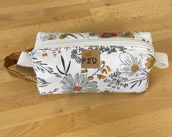 Handmade boxy pouch, dopp kit in Spring florals on cream background. The mid-size of a 3 piece set (sold seperately) .