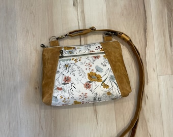 Floral Sunshine crossbody bag with waxed canvas accents and adjustable strap.
