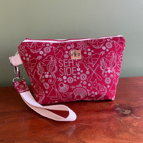 Ocean theme wristlet in fun red fabric. Perfect for a beach vacation.