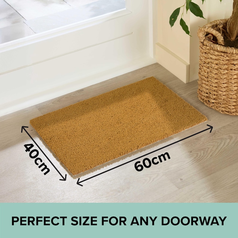May include: A rectangular doormat, 60cm long and 40cm wide, made of a natural brown material. The mat is placed in front of a white door and has the text "PERFECT SIZE FOR ANY DOORWAY".