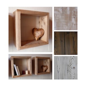 May include: Three wooden shelves with a heart-shaped wooden ornament on the top shelf and books on the bottom shelf. The shelves are made of reclaimed wood and have a rustic look.