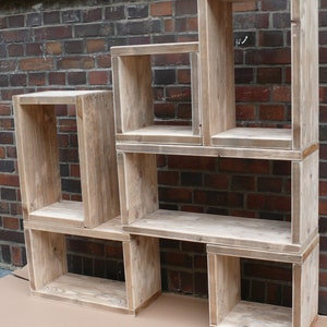 May include: A set of five wooden shelves, each with a different size and shape. The shelves are made of reclaimed wood and have a natural, rustic finish.