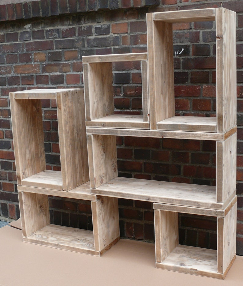 May include: A set of five wooden shelves, each with a different size and shape. The shelves are made of reclaimed wood and have a natural, rustic finish.