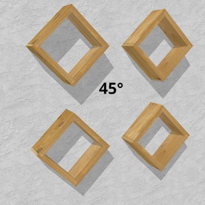 May include: Four wooden diamond-shaped shelves mounted on a white wall. The shelves are angled at 45 degrees.