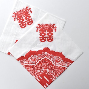 May include: White paper napkins with red Chinese double happiness symbols and floral patterns. The napkins are square-shaped and feature a decorative border design. Ideal for weddings or celebrations.