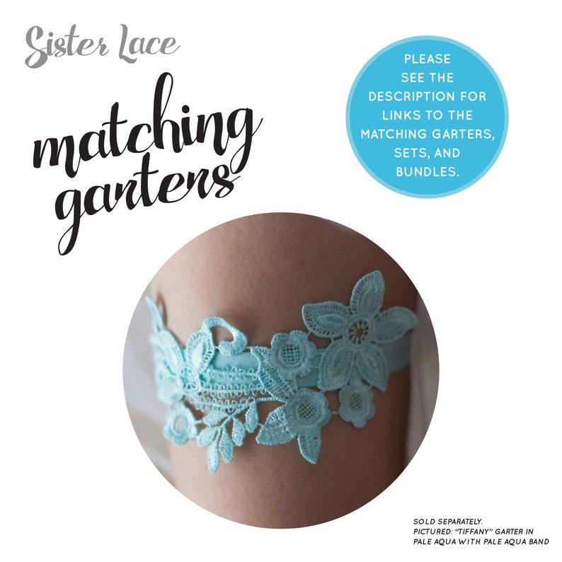 May include: A light blue lace garter with a floral design. The garter is pictured on a leg.  "Sold separately. Pictured: "Tiffany" garter in pale aqua with pale aqua band."