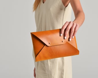 Ochre leather clutch bag, available with strap