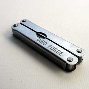 May include: A silver multi-tool with the words "Ohio Forge" engraved on the side.