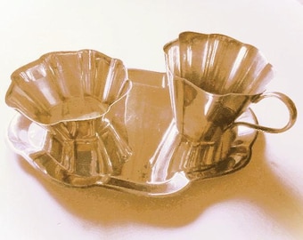 May include: A silver serving set with two cups and a tray. The cups have a fluted design and the tray has a scalloped edge.