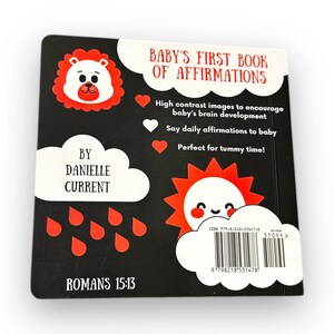 May include: A black and white book cover with a red lion illustration. The title is "Baby's First Book of Affirmations". The book is designed to encourage baby's brain development with high contrast images and daily affirmations. The back cover also includes the text "Romans 15:13".
